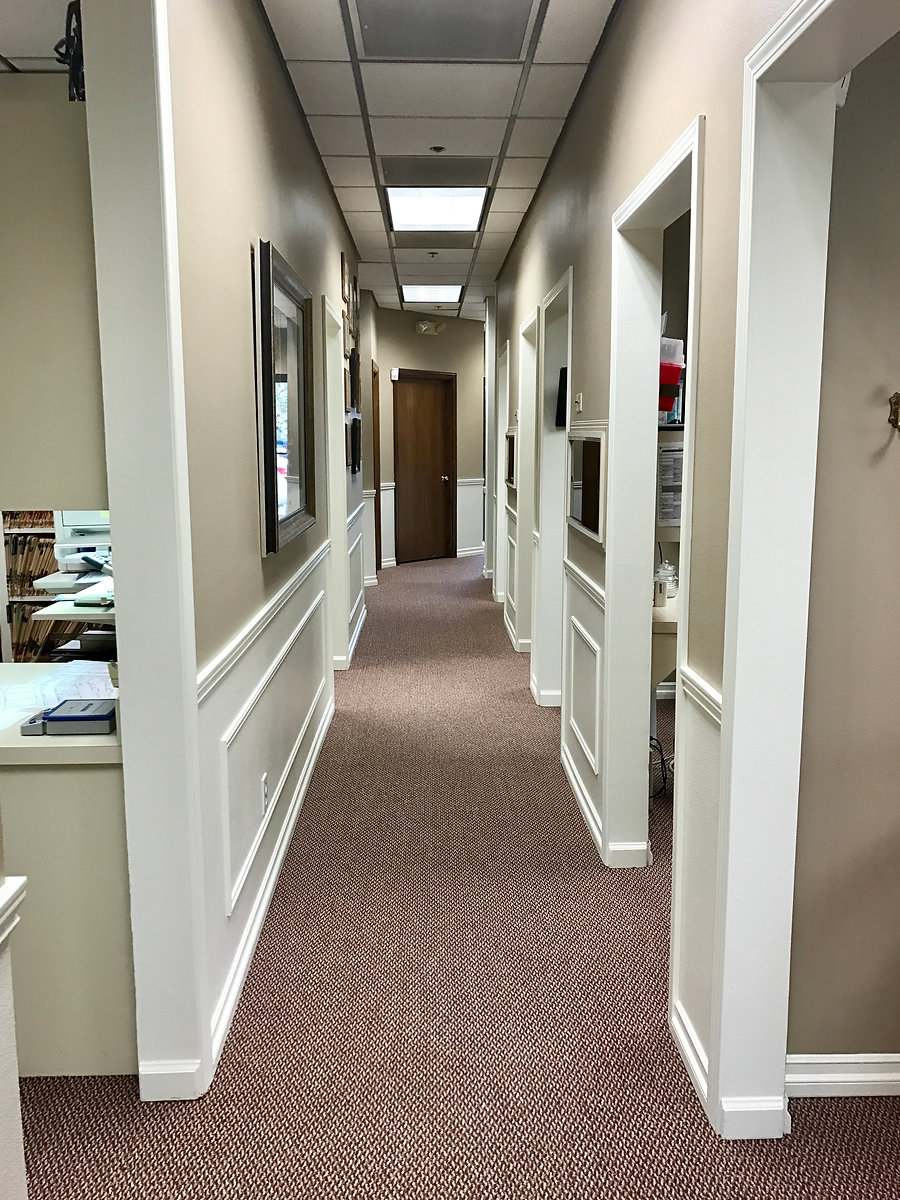 Bright, modern hallway leading to our treatment rooms